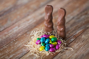 Image showing easter eggs in straw nest and chocolate bunnies