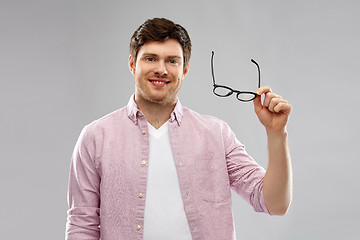 Image showing smiling man with glasses over grey background