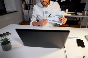 Image showing businessman having video chat at night office