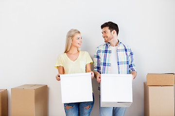 Image showing happy couple with boxes moving to new home