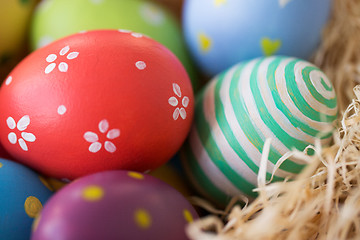 Image showing close up of colored easter eggs in straw