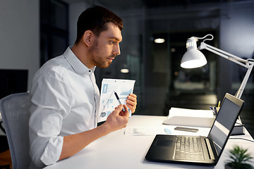 Image showing businessman having video chat at night office