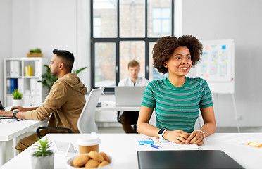 Image showing happy smiling african american woman at office