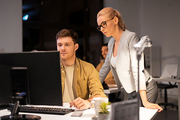 Image showing business team with computer working late at office