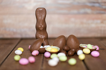 Image showing chocolate eggs, easter bunny and candies on wood