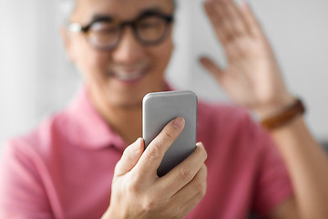 Image showing close up of man having video call on smartphone