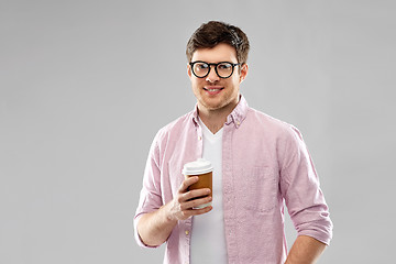 Image showing young man or student in glasses drinking coffee