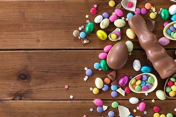 Image showing chocolate eggs, easter bunny and candies on wood