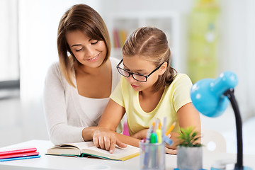 Image showing mother and daughter doing homework together