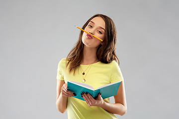 Image showing teenage student girl with notebook and pencil