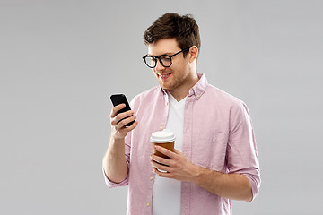 Image showing man in glasses with smartphone drinking coffee