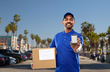 Image showing indian delivery man with smartphone and parcel box