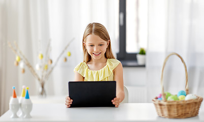 Image showing happy girl with tablet pc and easter eggs at home