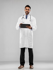 Image showing smiling indian male doctor with tablet computer