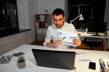 Image showing businessman having video chat at night office