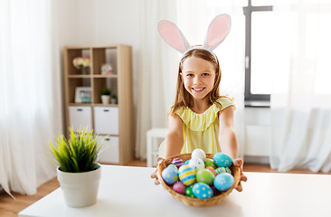 Image showing happy girl with colored easter eggs at home
