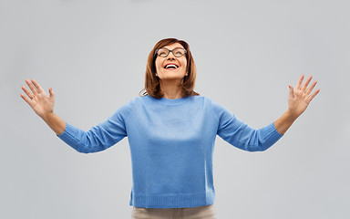 Image showing happy senior woman looking up thanks god