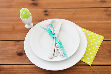 Image showing easter egg in cup holder, plates and cutlery