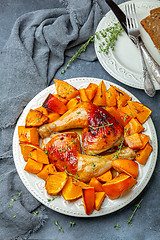 Image showing Chicken thighs and baked pumpkin and orange slices.