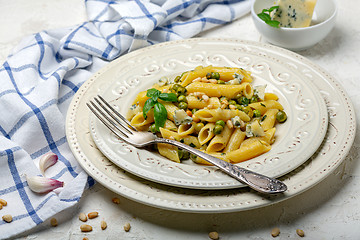 Image showing Delicious pasta with green peas and blue cheese.