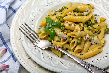 Image showing Penne pasta with green peas close up.