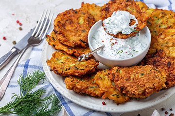 Image showing Delicious zucchini fritters with yogurt sauce.