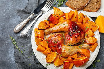 Image showing Chicken thighs and baked pumpkin.