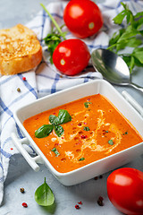 Image showing Spicy tomato soup with green basil.