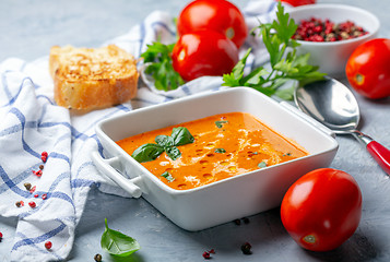 Image showing Tomato soup with green basil.