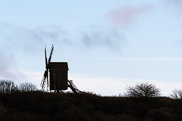 Image showing Silhouetted old wooden windmill