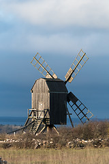 Image showing Sunlit old wooden windmill