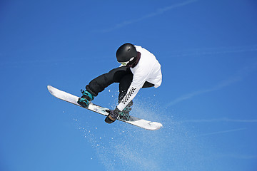 Image showing Snowboarder jumping through air with sky in background