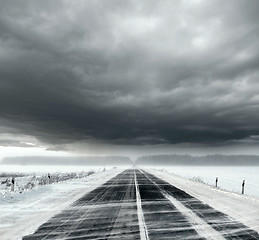 Image showing Stormy sky and snow road