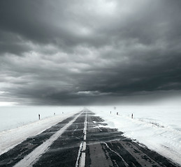 Image showing Stormy sky and snow road