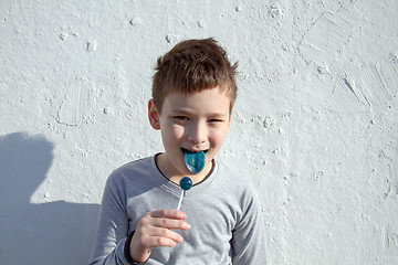 Image showing Boy with blue lollipop