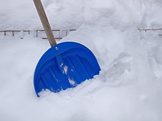 Image showing Big blue plastic shovel on fresh snow