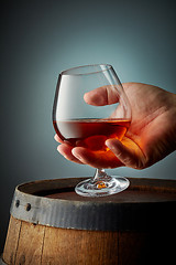 Image showing glass of cognac in human hand