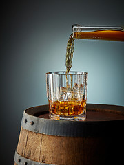 Image showing whiskey pouring into glass