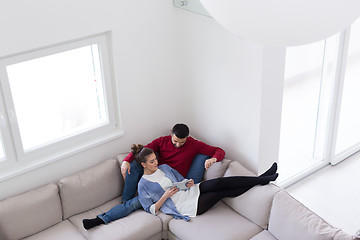 Image showing couple relaxing at  home with tablet computers