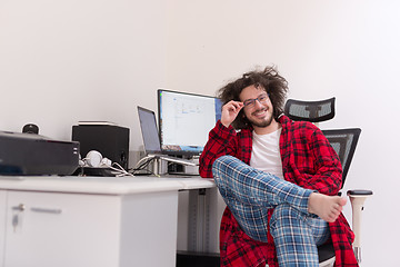 Image showing graphic designer in bathrobe working at home