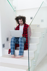 Image showing freelancer in bathrobe working from home