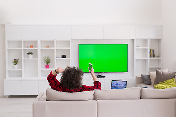 Image showing young man in bathrobe enjoying free time