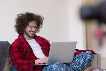 Image showing man freelancer in bathrobe working from home