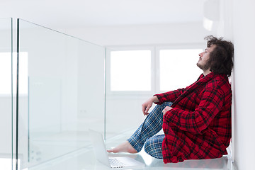 Image showing young freelancer in bathrobe working from home