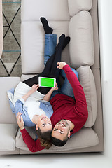 Image showing couple relaxing at  home with tablet computers