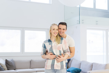 Image showing couple hugging in their new home