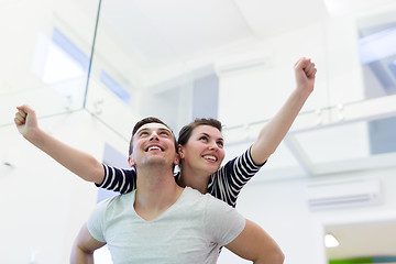 Image showing handsome man piggybacking his girlfriend