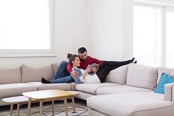 Image showing couple relaxing at  home with tablet computers