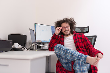 Image showing graphic designer in bathrobe working at home