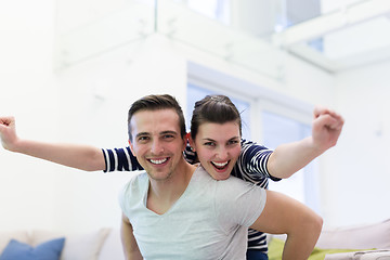 Image showing handsome man piggybacking his girlfriend